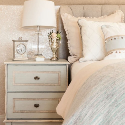 bed with bedside table lamp and clock in Harwich Port MA