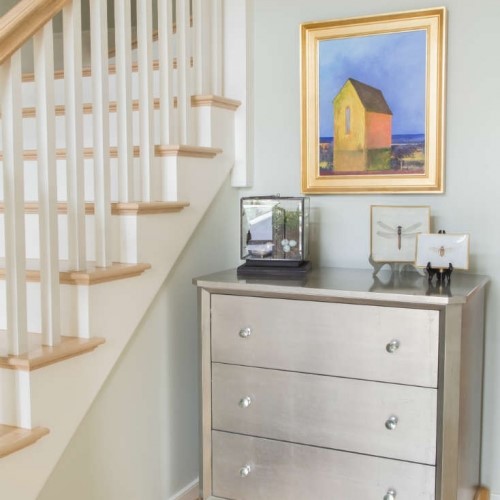 dresser and pictures in nook next to stairs in Yarmouth Port MA